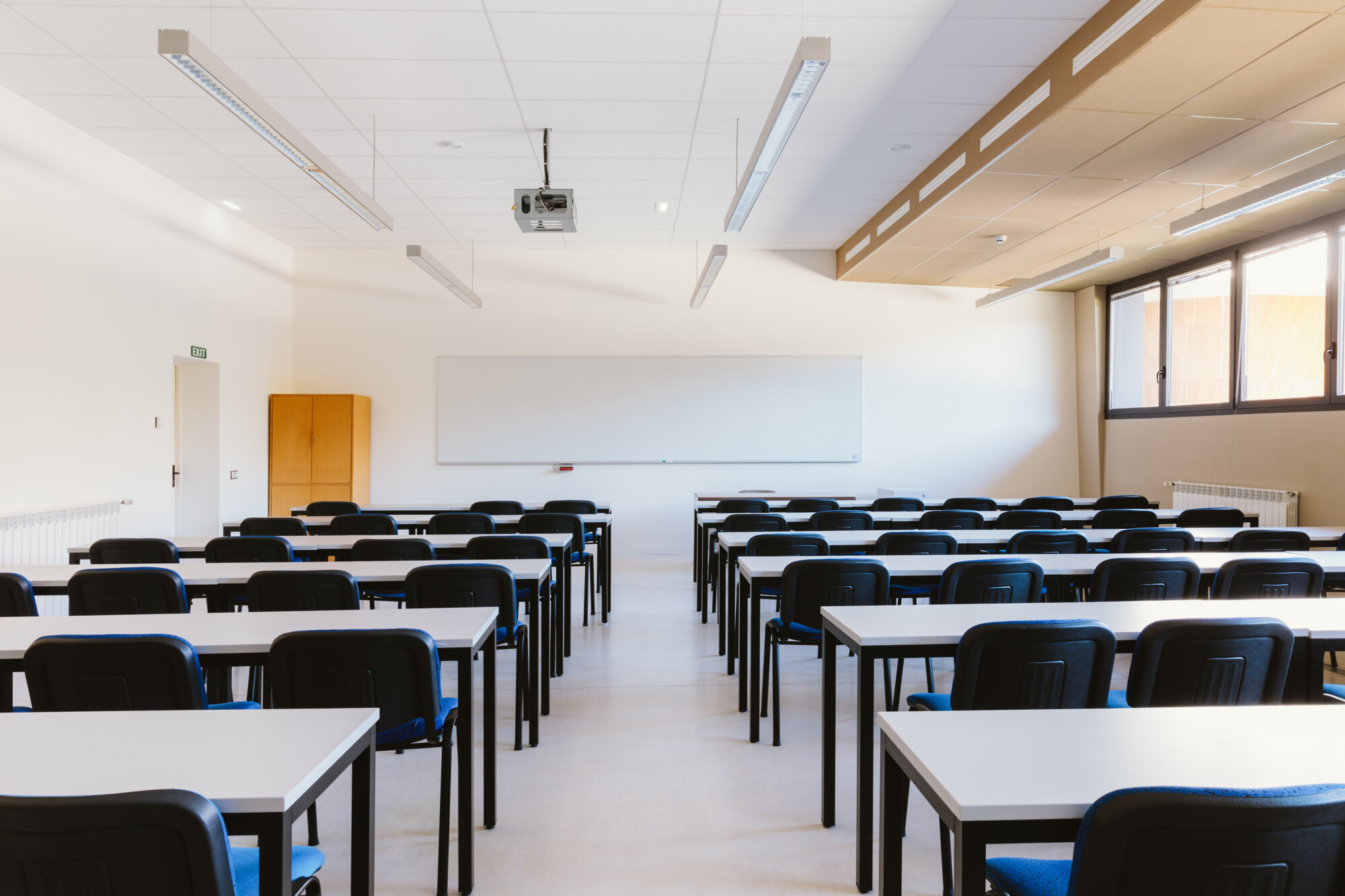 White classroom in education university with blue chairs