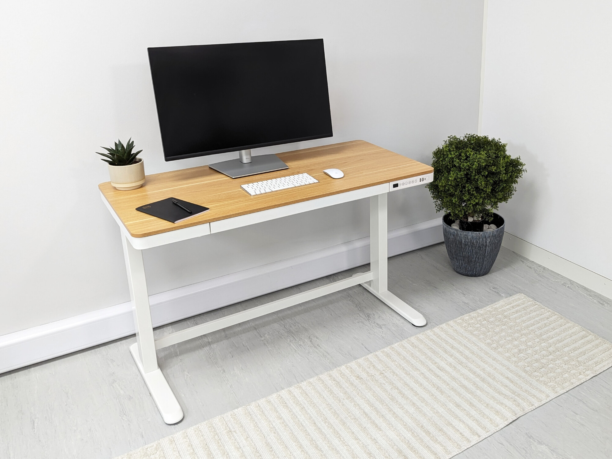 The Saturn Height Adjustable Desk offers a Scandinavian aesthetic blending maple wood and classic white to bring a sense of elegance to any home office. 